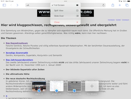 The small multitasking menu is at the top, while various app windows are at the bottom.